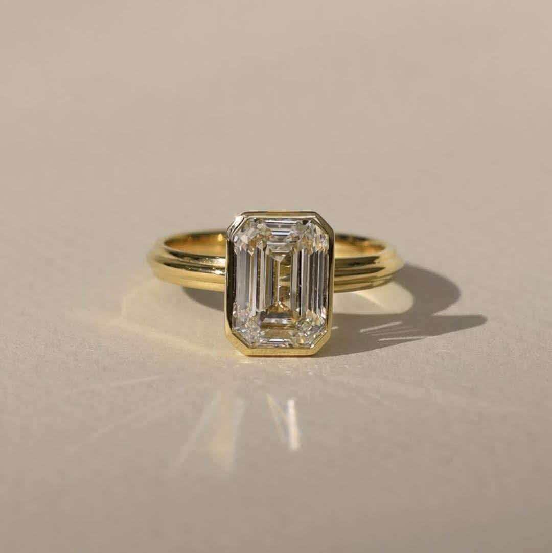 faa0a34f2ab045d2b8644e61b907de66 3-Carat Lab-Grown Emerald-Cut Diamond Ring: D Color, VVS2 Clarity in 14K Yellow Gold - Image 1